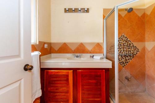 a bathroom with a sink and a shower at Nicely Priced Duplex in Surfside with Private Pool and AC in Every Room in Potrero