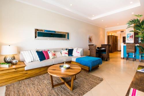 a living room with a couch and a table at Stunning Ocean View with 2 Pools - Flamingo and Conchal Beaches in Playa Flamingo