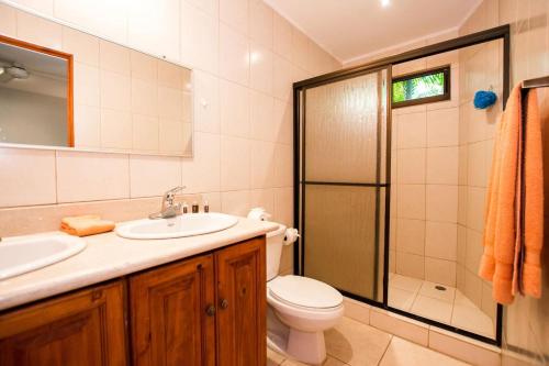 a bathroom with a toilet sink and a shower at Charming unit that sleeps 4 - with pool - walking distance from Brasilito Beach in Brasilito