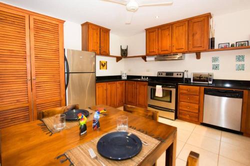 a kitchen with a wooden table with two toy figures on it at Charming unit that sleeps 4 - with pool - walking distance from Brasilito Beach in Brasilito