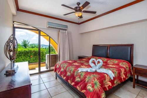a bedroom with a bed and a large window at Big-beautiful unit in Flamingo sleeps 8-with breathtaking ocean views in Playa Flamingo