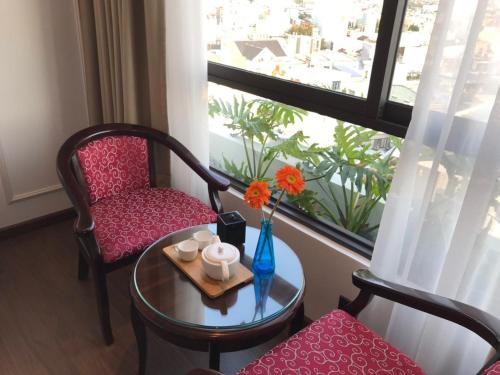 une chambre avec une table, une chaise et une fenêtre dans l'établissement Khanh Linh Hotel, à Đà Nẵng