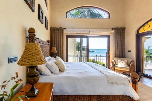 a bedroom with a bed with a view of the ocean at Mediterranean-style Flamingo mansion offers the ultimate in beachfront luxury in Playa Flamingo