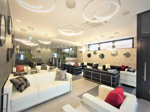 a living room with couches and a salon at Green Rich Hotel Yonago Ekimae (Artificial hot spring Futamata Yunohana) in Yonago