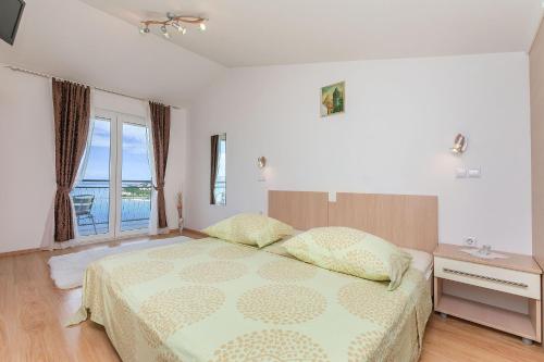 a bedroom with a bed with a view of the ocean at Apartments Mia in Omiš