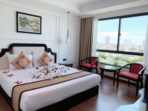 a hotel room with a bed with flowers on it at Khanh Linh Hotel in Danang