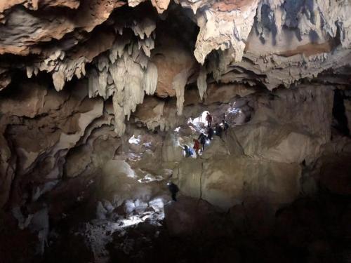 a group of people standing in a cave at Leisure Courtyard Hotel Yangshuo in Yangshuo