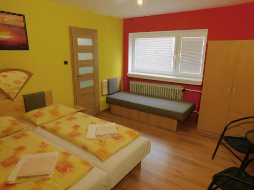 a small room with two beds and a window at Pod Dubom in Liptovský Mikuláš
