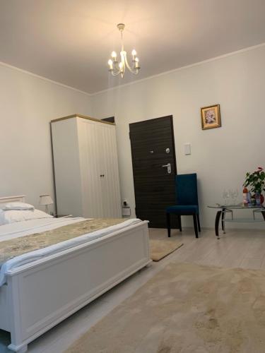 a bedroom with a bed and a table and a chair at Studio Katerina in Mamaia