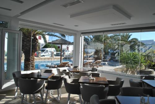 a dining room table with chairs in front of it at Petinaros Hotel in Mikonos