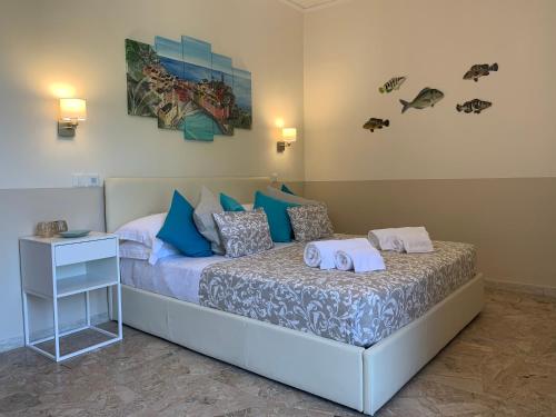 a bedroom with a bed with blue and white pillows at Affittacamere San Giorgio in Manarola