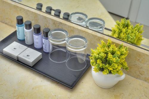 a group of glass jars on a counter with a vase with flowers at Tzuba Hotel in Ẕova