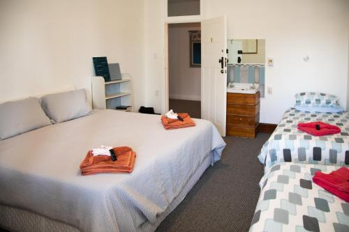 a bedroom with two beds with towels on them at The Brown Pub in Methven