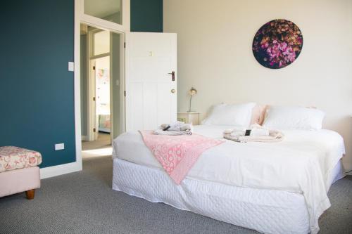 a bedroom with a large white bed with towels on it at The Brown Pub in Methven