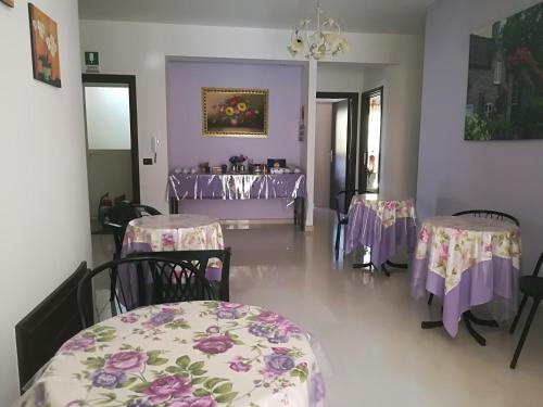 a room with tables and chairs with purple table cloth at Villa delle rose in Bova Marina