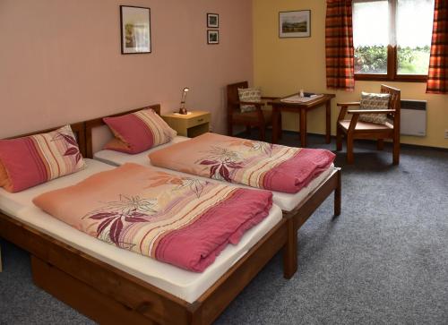 A bed or beds in a room at Hostinec U Čertova mlýna