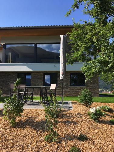 a building with a table and chairs in front of it at Ferienhaus Raich in Vandans