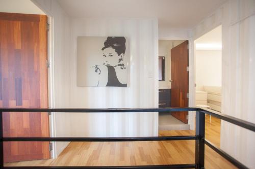 a room with a staircase and a painting on the wall at Bamboo Garden House in Laem Sing