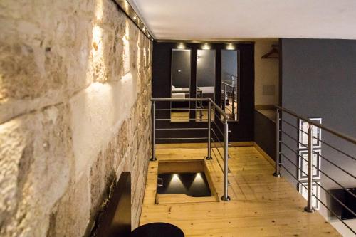 a hallway with a wooden floor and a wall at "Here" Mini loft Alghero in Alghero