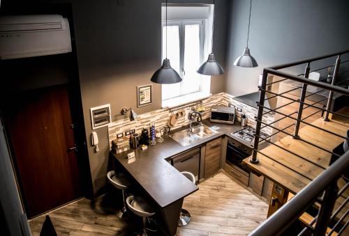 a kitchen with a sink and a counter top at "Here" Mini loft Alghero in Alghero