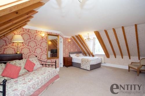 a bedroom with two beds and a tv in it at Woodlands Lodge Hotel in Bartley