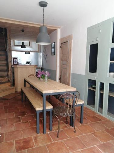 a dining room with a wooden table and chairs at File dans ta chambre ! in Le Monastier sur Gazeille