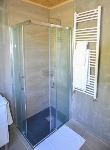 a shower with a glass door in a bathroom at CELTAINER in Maceda