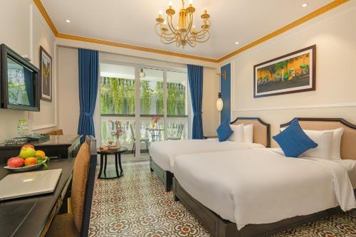 Giường trong phòng chung tại Hoi An Blue Sky Boutique Hotel & Spa