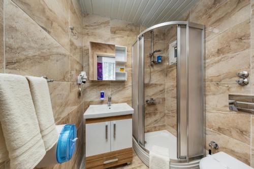 a bathroom with a shower and a sink at Anelli Hotel in Antalya