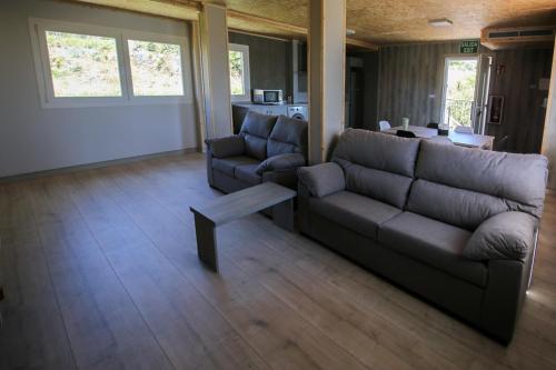 a living room with a couch and a table at CELTAINER in Maceda