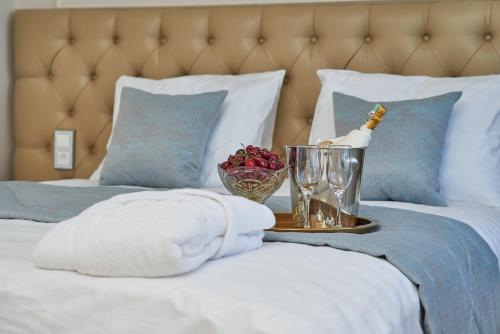 a bed with a bottle of champagne and glasses on it at Rakhat Hotel in Uralsk
