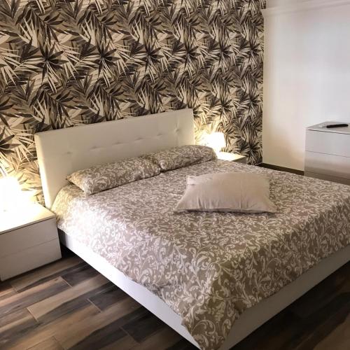 a bedroom with a large bed with a white bedspread at Exclusive Rooms in Trinitapoli
