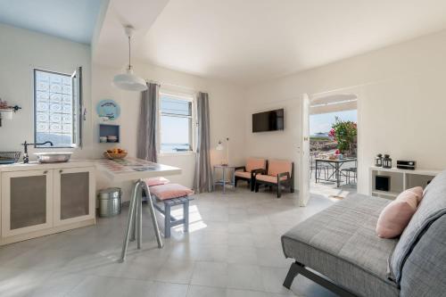 a kitchen and a living room with a couch and a table at Kimolian Houses in Kimolos