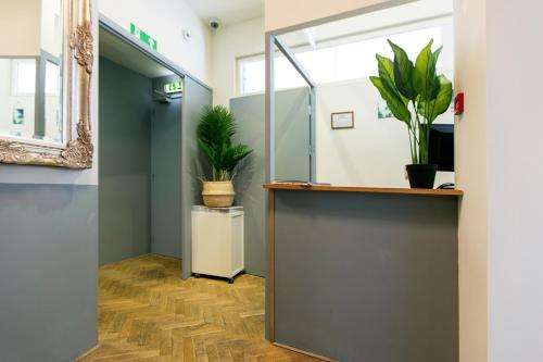 an office hallway with plants on the wall at Quentin Arrive Hotel in Amsterdam