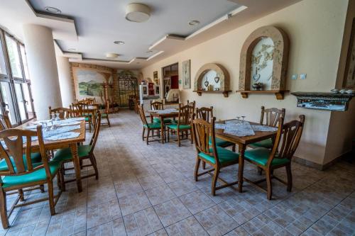 a dining room with wooden tables and chairs at Hotel TEX Club in Botoşani