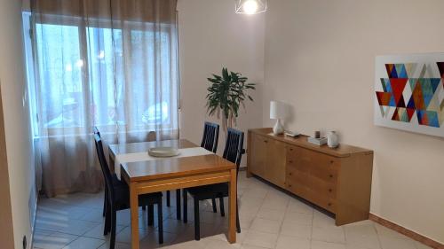 a dining room with a table and chairs and a dresser at TOP Apartment in Catanzaro