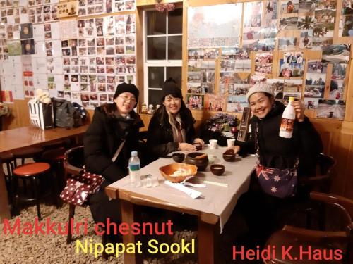 three women sitting at a table in a restaurant at Heidi Korea in Hongcheon