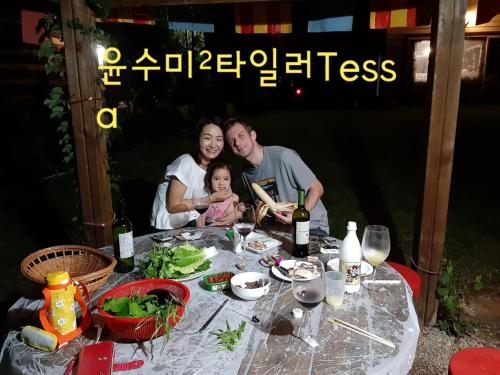 a family posing for a picture at a table with food at Heidi Korea in Hongcheon