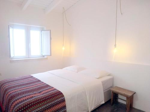 En eller flere senge i et værelse på Casa Pe do Castelo