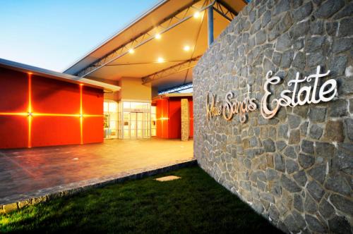 a building with a sign on the side of it at White Sands Estate in Falmouth