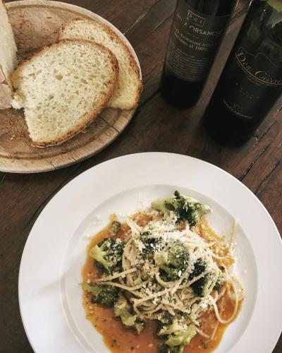 a plate of food with pasta and broccoli and bread at Tenuta Orsanese in Ginosa Marina