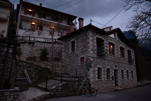 a brick building with two bikes parked in front of it at Sokaki in Méga Khoríon