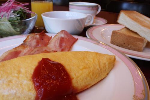 a plate of food with a omelet on a table at Hotel 21 in Kusatsu