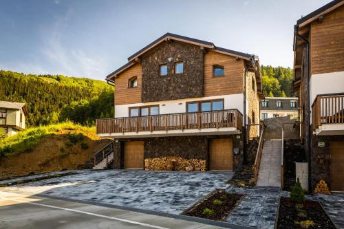 a large house with a balcony and a driveway at Horská Chata Ostružiny in Donovaly