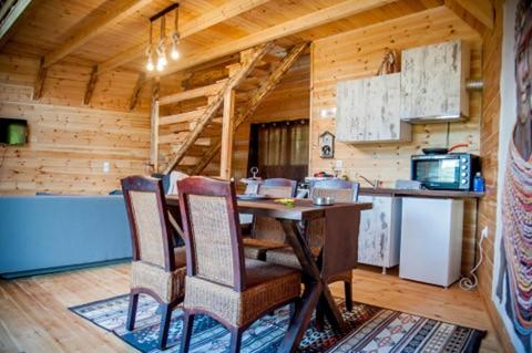 a kitchen with a table and chairs in a cabin at Kedra Village in Kédra