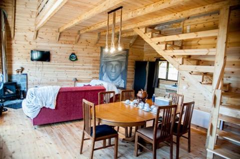 a dining room with a table and a couch at Kedra Village in Kédra