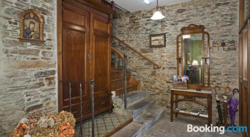 a room with a stone wall and a wooden door at Casa Soto in Vegadeo