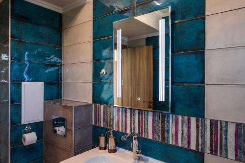 a bathroom with a sink and a mirror at Villa Flora in Sozopol