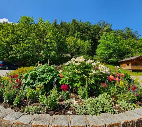 a flower garden with colorful flowers in a yard at Hotel-Gasthof Mauthäusl in Weißbach