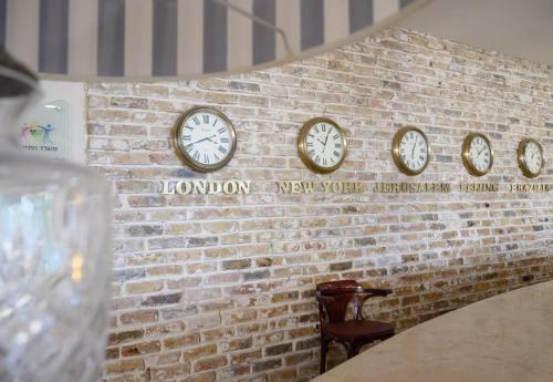 a row of clocks on a brick wall at Royal Plaza Hotel in Tiberias